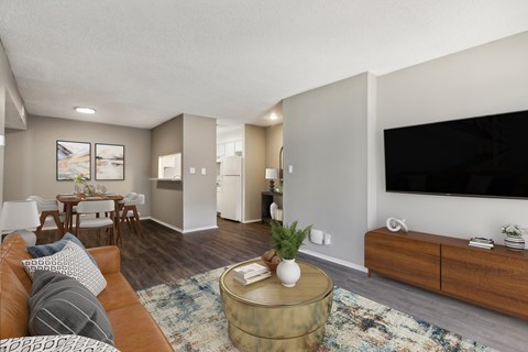 A living room with a brown couch and a coffee table.